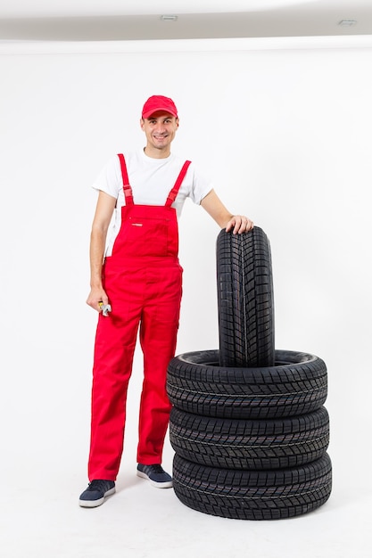 Auto mechanic with tools on a white background