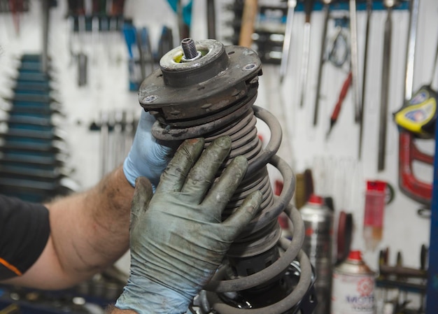 Auto mechanic working on car engine in mechanics garage Repair service authentic closeup shot
