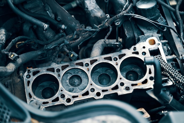 Auto mechanic working in garage repair service the connecting\
rod piston and cylinder block in a dis...