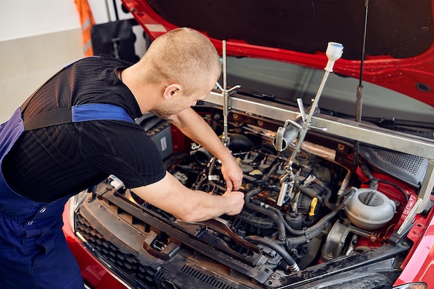 Auto mechanic working in the garage