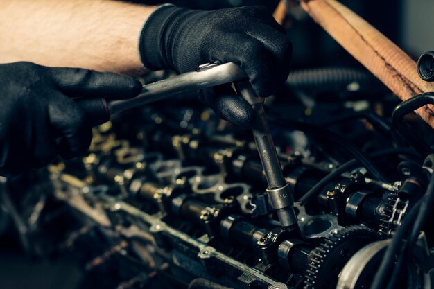 auto mechanic working and repair on car engine in mechanics garage