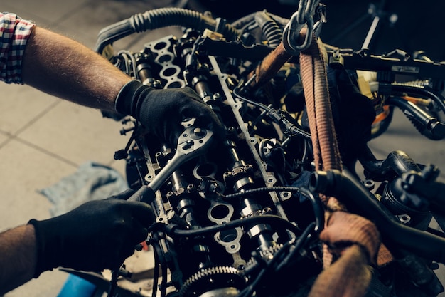 Photo auto mechanic working and repair on car engine in mechanics garage