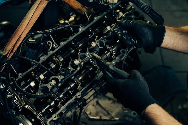 Auto mechanic working and repair on car engine in mechanics garage