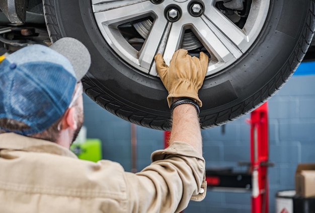 Photo auto service worker is about to change brake discs and braking pads