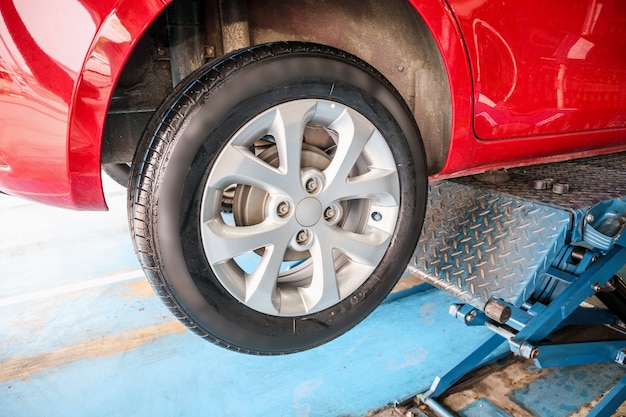 Auto tire replacement at car service centre repair shop