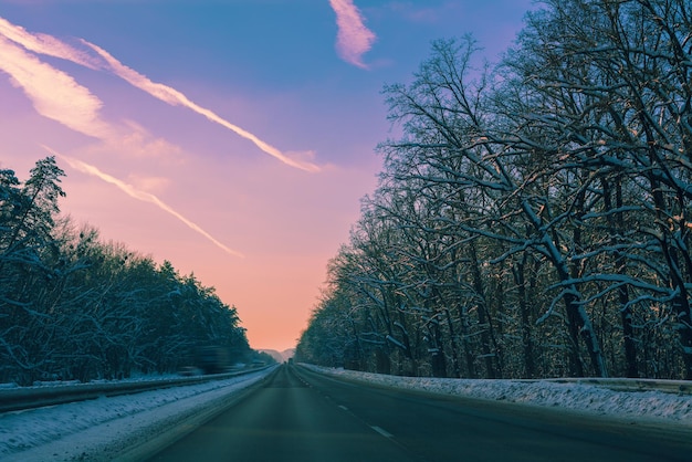 Autobahn in winter at purple sunset