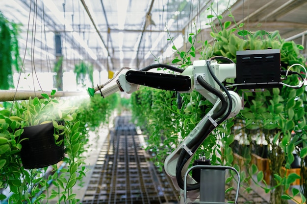 Photo automatic agricultural technology robot arm watering plants tree