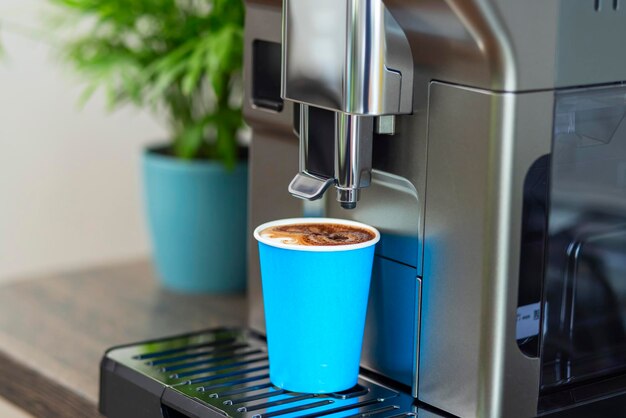 Automatic coffee machine dispensing espresso into cup