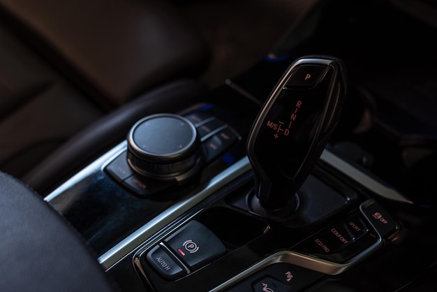 Automatic gear stick of a modern car Control buttons Car interior details