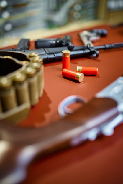 Automatic and hunting rifles on counter in gun store closeup, nobody. Weapon shop, ammunition assortment, firearms choice, shooting hobby and lifestyle, self protection and security