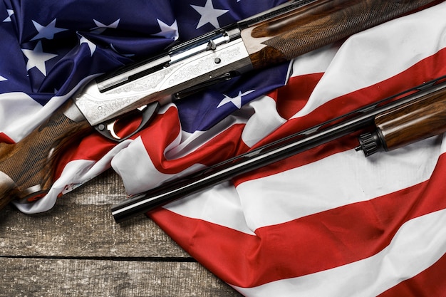 Automatic rifle on usa flag on wooden background