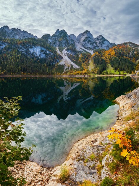 Autumn alpine lake with clear transparent water and reflections Gosauseen lake Austria