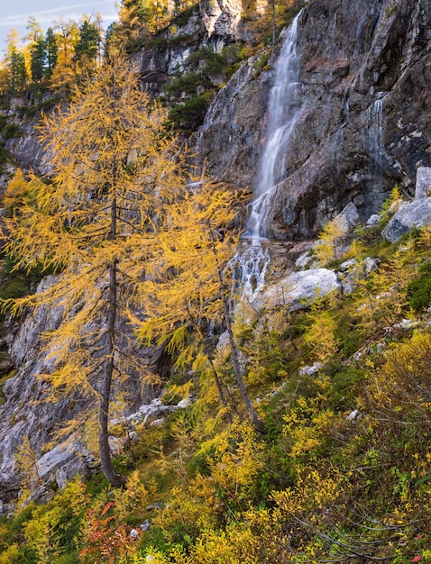 Autumn alpine waterfall view from mountain hiking path to Tappenkarsee Kleinarl Land Salzburg Austria