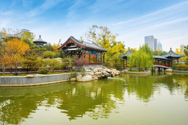 In autumn, ancient buildings and arch bridges are in Yingze Park, Taiyuan, Shanxi Province, China