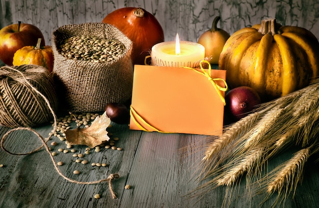 Autumn arrangement on wood and greeting "Happy Thanksgiving" on card