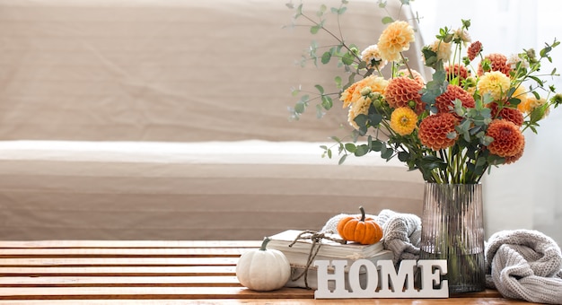 Autumn background with a bouquet of chrysanthemums and pumpkins copy space