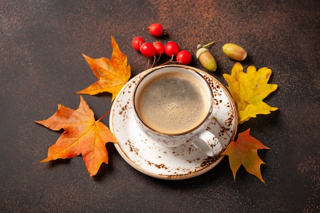 Autumn background with cup of black coffee