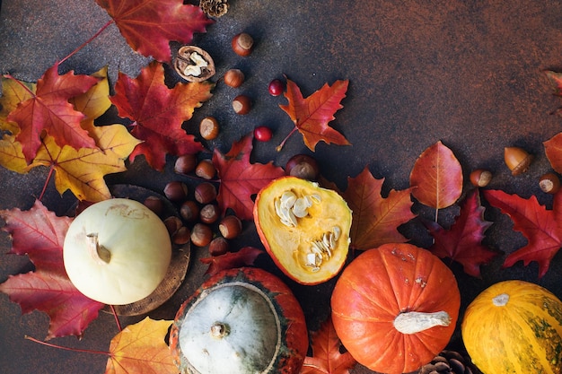 暗い石のテーブル収穫静物組成感謝祭の背景に装飾的なカボチャの実と秋の葉と秋の背景