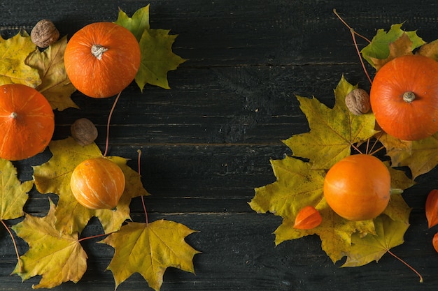 Autumn background with dry leaves and pumpkins for thanksgiving