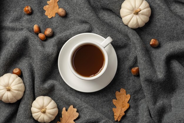 Autumn background with plaid leaves and coffee