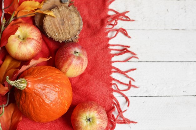 Autumn background with pumpkin, apples and leaves