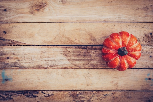 autumn background with pumpkin on wooden board with space, Vintage filter.