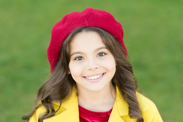 Autumn beauty. cheerful little girl in yellow coat. parisian girl kid in french beret. beauty and fashion. autumn coat. happy childhood. small child with curly hair. autumn fashion style. fall season.