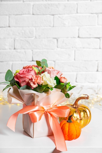 Autumn bouquet of flowers and pumpkins on a white background with beautiful bokeh free space for