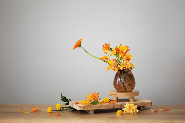 Autumn bouquet on wooden shelf on background gray wall
