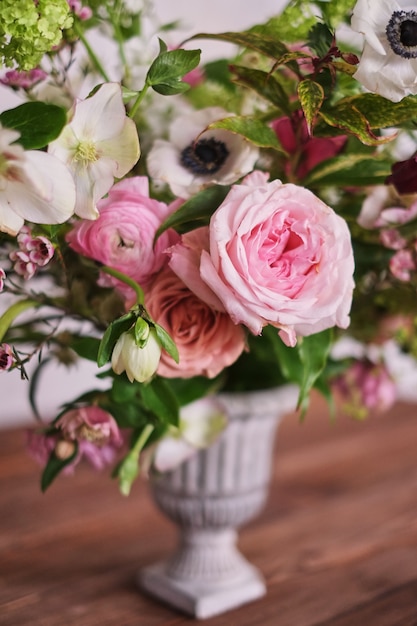 Autumn bridal bouquet of flowers stands on a brown wooden table side view