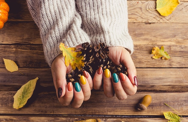 Autumn chic cozy knits and trendy nails rustic wooden background fall vibes