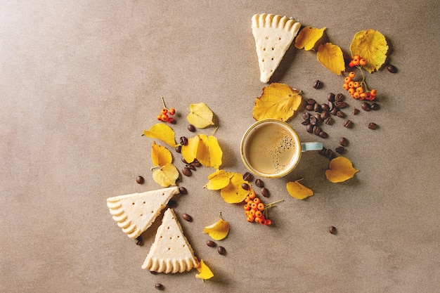 Autumn coffee with yellow leaves