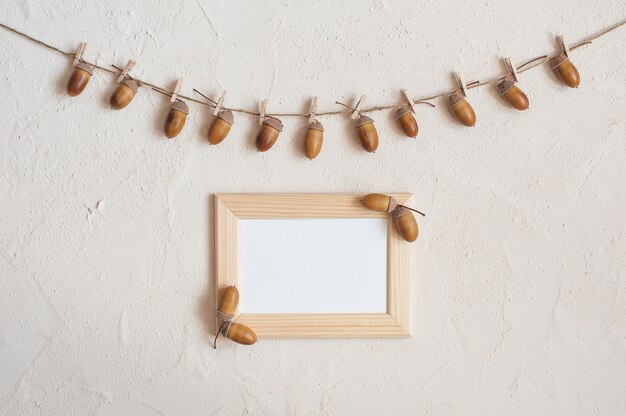 Photo autumn composition. acorn with clothespins on clothes line rope. wooden pegs.