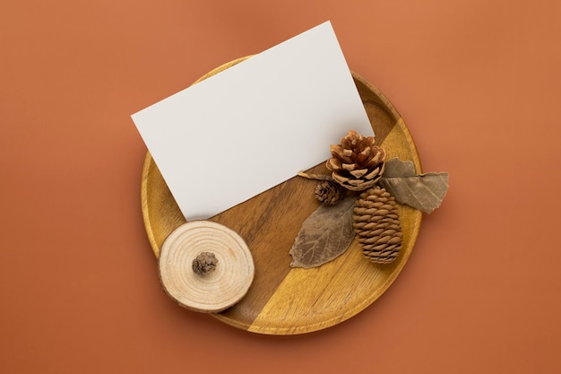 Autumn composition Blank paper cards Mockup with dried leaves  and pine cones on brown background Fl