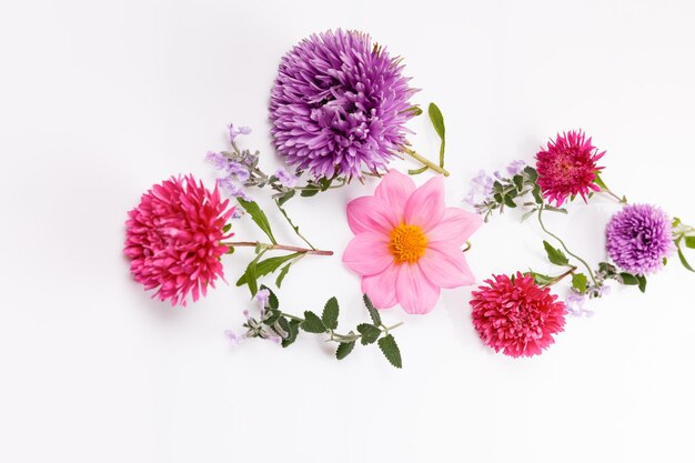 Autumn composition. Frame made of autumn dried flowers and leaves on white background. Flat lay, top view, copy space