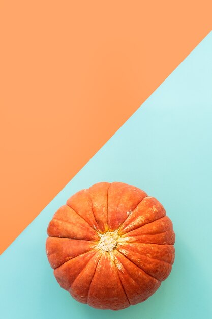 Autumn composition. Pumpkins on blue and orange