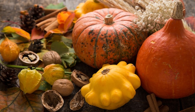 Autumn composition with colorful fresh pumpkins and autumn leaves, Thanksgiving, autumn background