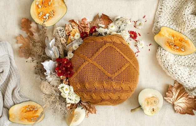 Autumn composition with flowers, pumpkins and knitted elements copy space.