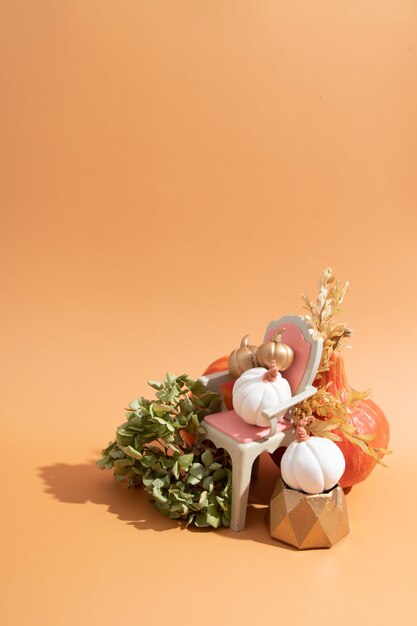 Autumn creative still life of pumpkins, dried flowers with a candle with copy space