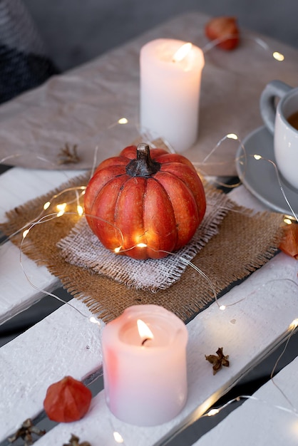 Autumn decor of pumpkins and candles in october idea for halloween