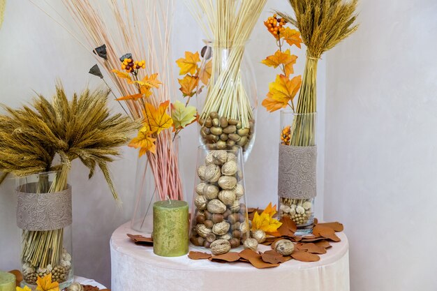 Autumn decoration of nuts from yellow leaves and candles. Autumn decoration for interior handmade