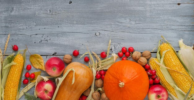 Autumn decoration wooden table with pumpkins corn apples