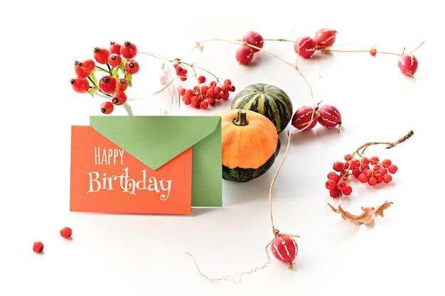 Autumn decorations card with text Happy Birthday text Natural decorative Fall pumpkins and red climbing plants Natural seasonal Fall decor