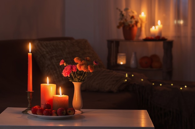 Autumn decorations with burning candles at home