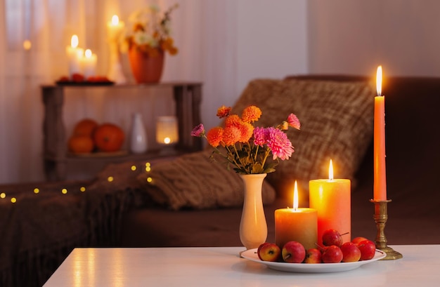 Autumn decorations with burning candles at home