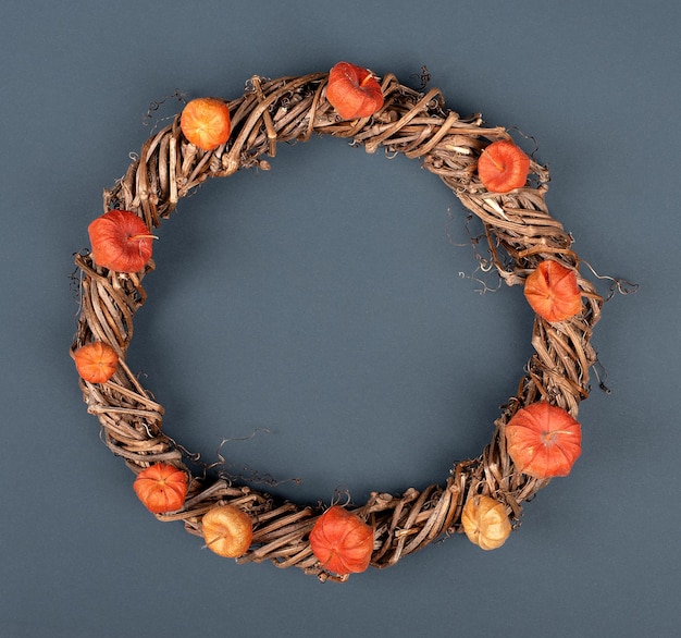 Autumn decorative wreath of branches on a gray background copy space flat lay