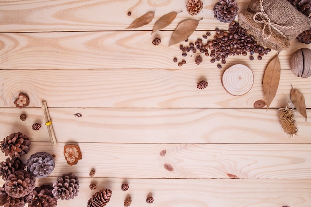 Autumn dry leaves on wooden brown background top view