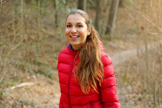 Autumn fall portrait of happy lovely young woman in forest