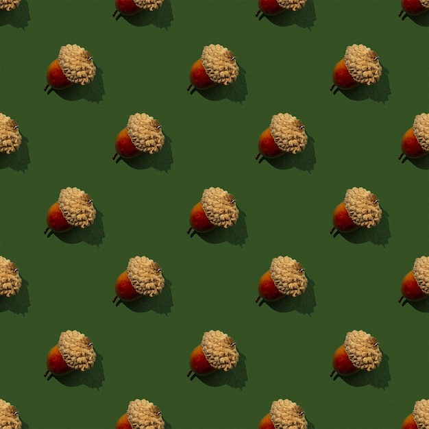 Autumn and fall seamless pattern with acorns on a green background