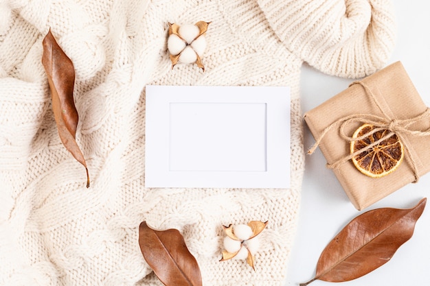 Autumn flat lay composition with craft gift and dried leaves 